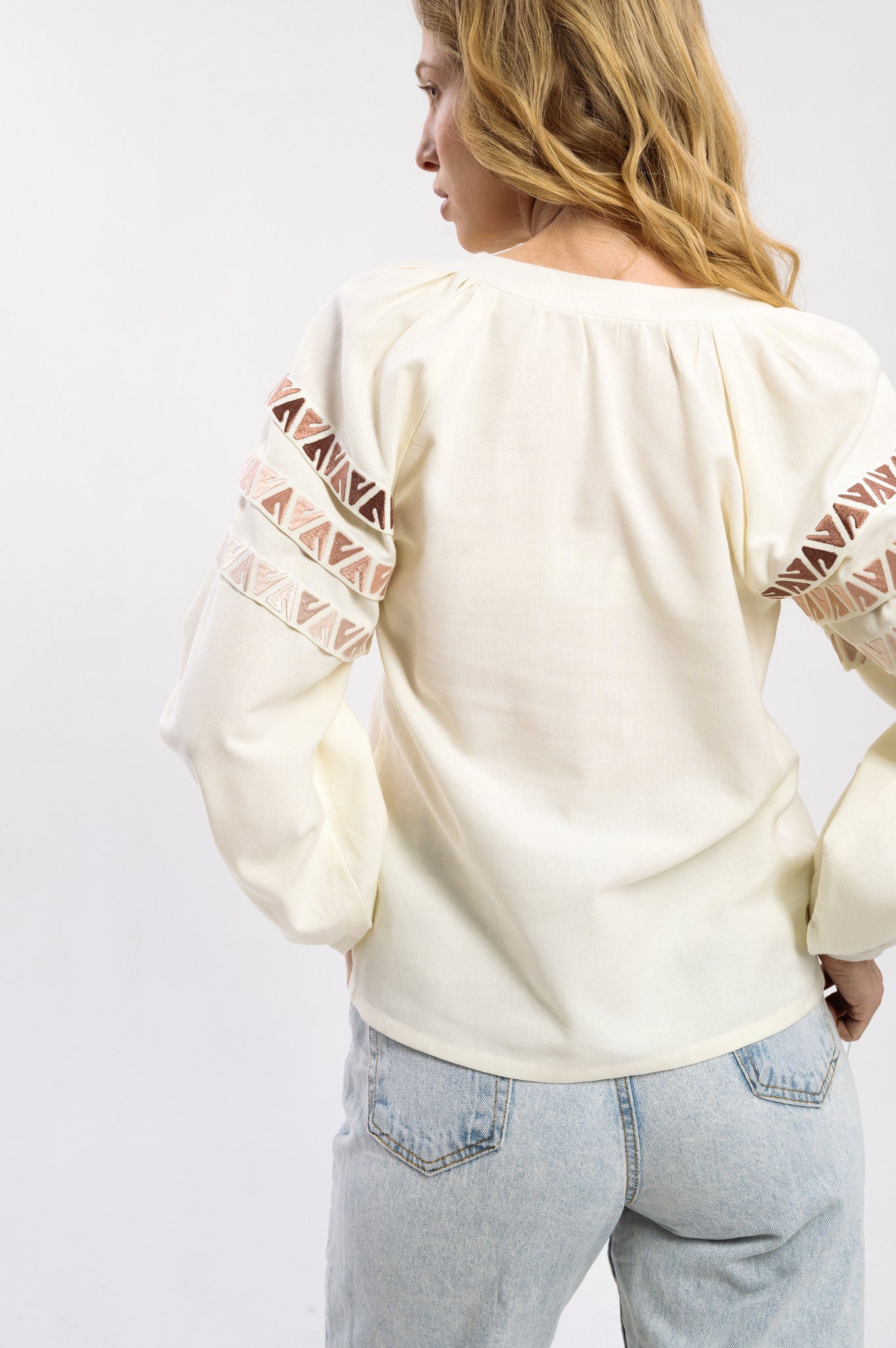 Elegant Cream-Colored Blouse With Ethnic Accents On The Sleeves Ornament