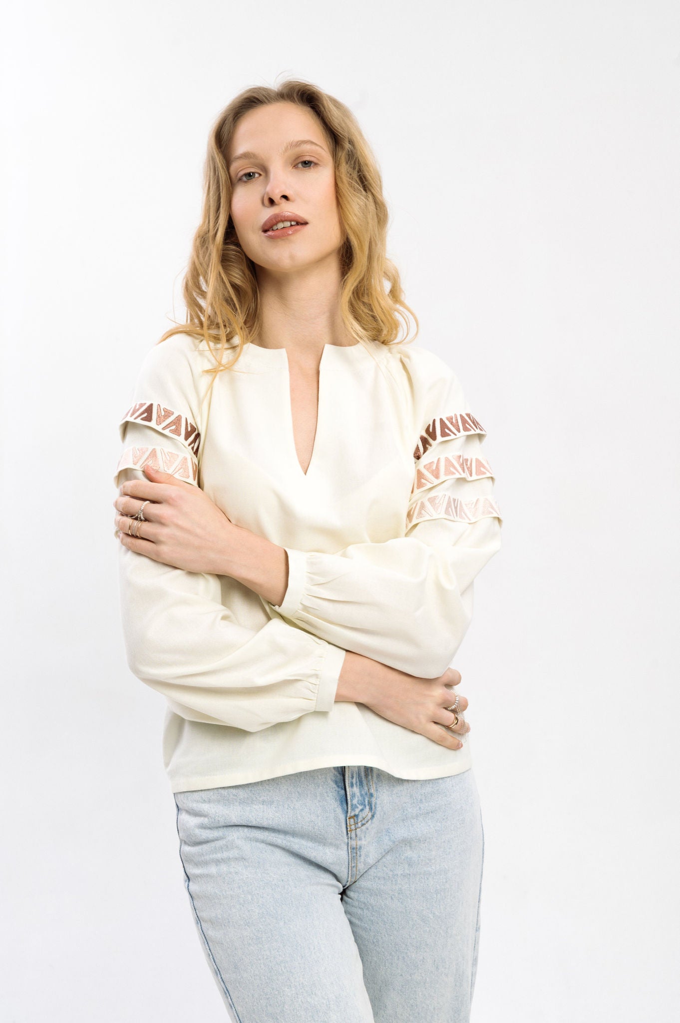 Elegant Cream-Colored Blouse With Ethnic Accents On The Sleeves Ornament
