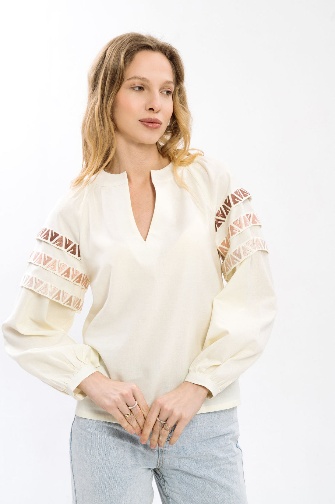 Elegant Cream-Colored Blouse With Ethnic Accents On The Sleeves Ornament